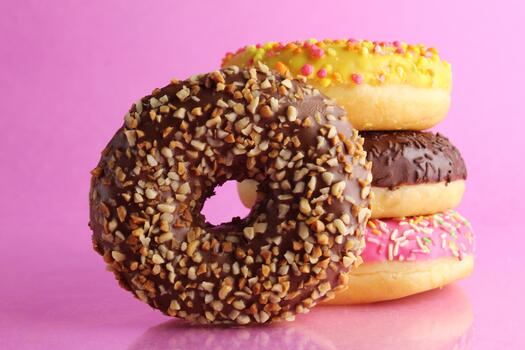 Sweet still life donut berliner close-up at the back lie a stack of three doughnut with a place for text and with a cpixpe for a cafe for tablecloths for glue photo