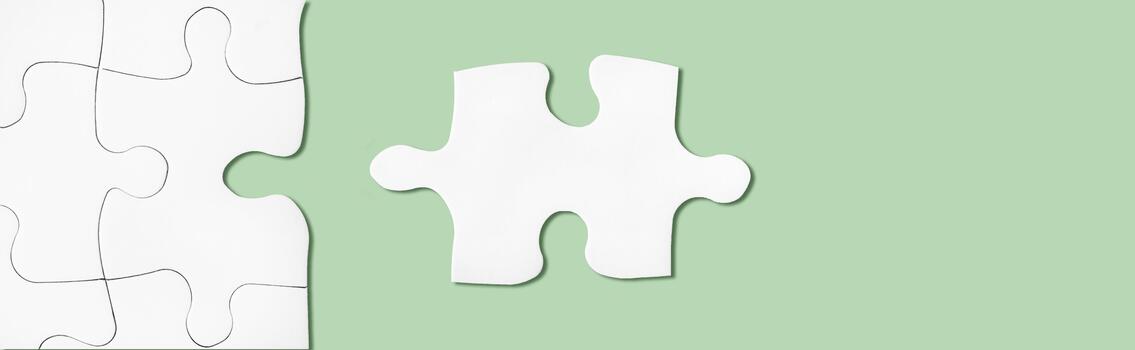 Puzzle on green surface. Connecting, network idea. Metaphor of teamwork, problem solving photo