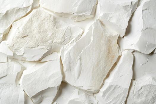 White textured stone wall featuring smooth, uneven surfaces and natural patterns, creating a visually appealing backdrop with copy space for design purposes photo