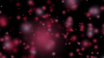 Abstract festive shiny red bokeh lights create a beautiful glowing particle effect on a dark background for celebration design video