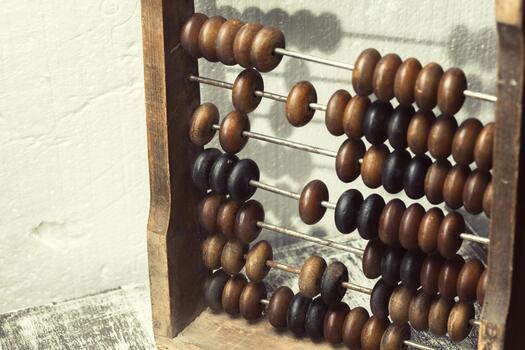 Classic wooden abacus used for counting and calculations in a simple workspace photo