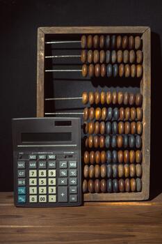 Calculator and abacus demonstrate ancient and modern calculation methods side by side photo