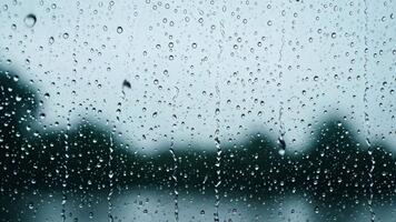 Raindrops on window close up view abstract background moody atmosphere video