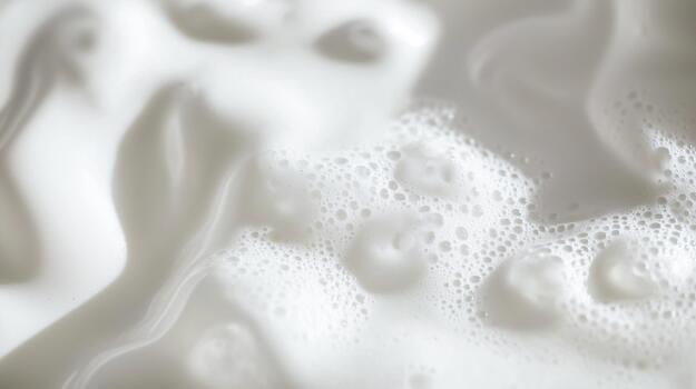 Creamy white liquid with bubbles and smooth texture, creating a soft and inviting appearance, ideal for culinary or beverage concepts and visual storytelling photo