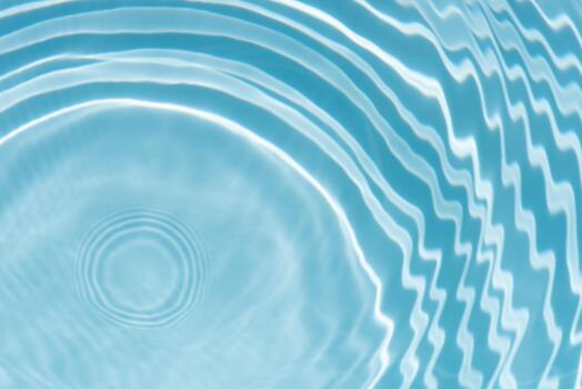 Blue water with ripples on the surface. Defocus blurred transparent blue colored clear calm water surface texture with splashes and bubbles. Water waves with shining pattern texture background.24 photo