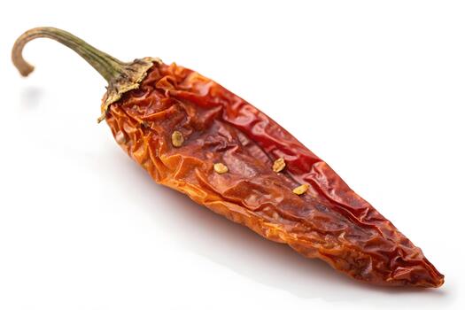 Hyper-detailed close-up of one chili fragment revealing dry wrinkled surface, seed traces, and sharp contours on a clean isolated white surface. photo