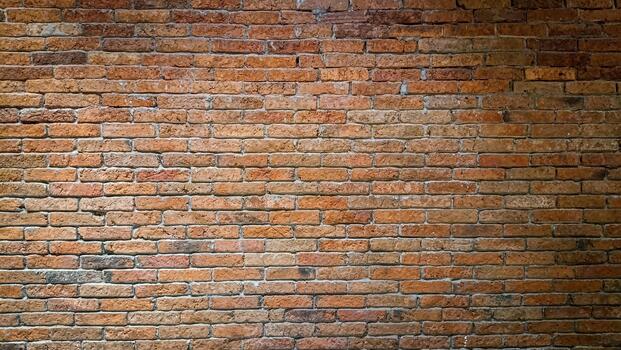 Detailed full frame view of an old brick wall featuring weathered bricks in shades of brown and orange, creating a textured surface suitable for backgrounds and design mockups. photo