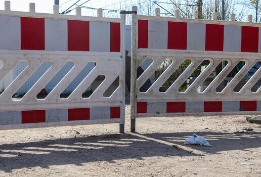 Temporary red and white construction barriers blocking access photo