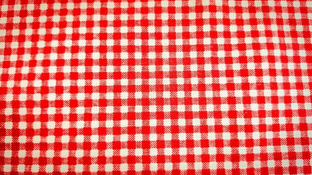 A seamless red and white gingham checkered pattern featuring alternating squares in a classic grid layout photo