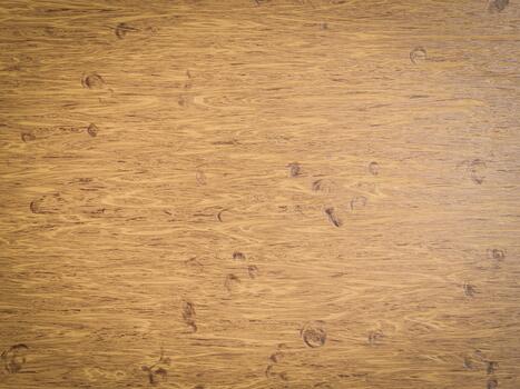 Light honey-colored wood with circular marks and flowing grain pattern visible across the surface. photo