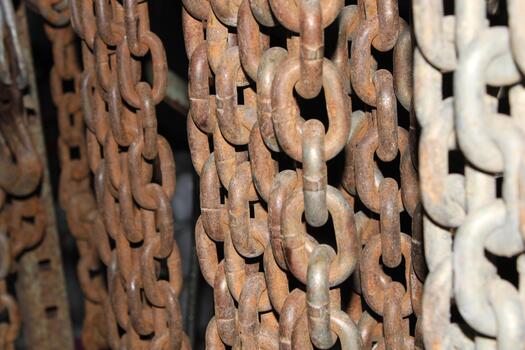 Different Colored Metal Chains Hanging In A Workshop photo