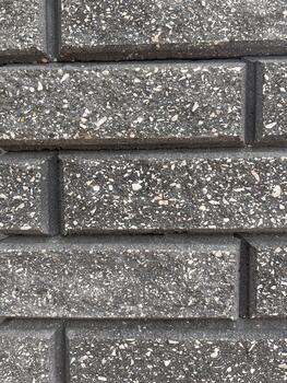 Close-up view of textured stone bricks arranged in a neat pattern in a contemporary construction setting photo