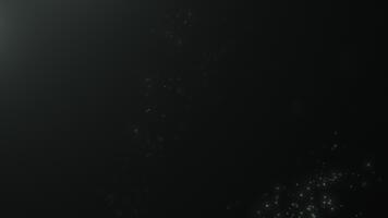 Shimmering dust motes float in the air. A dust-filled background with beautiful bokeh. Elegant, slow-motion macro photography. Seamless, looping 4K . video