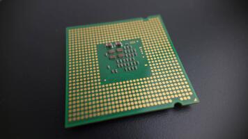 Macro rotating view of a modern CPU underside without pins, showing contact pads and processor structure for hardware, electronics and tech presentations video