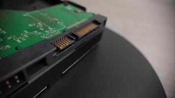 Close-up rotating view of a hard drive showing power and data connectors, ideal for technology, hardware, storage devices and computer component visuals video