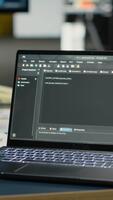 vertical cerca arriba de ordenador portátil en vacío ai empresa oficina usado a tren profético modelos para idioma Procesando tareas. profundo aprendizaje tecnología software desplegado en cuaderno en eso oficina video