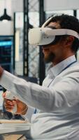 verticale programmatore nel ufficio utilizzando virtuale la realtà Tech per fix pirateria tentativo su aziendale Rete. esso esperto usi vr cuffia per indagare non autorizzato accesso avvisi, Lavorando per mitigare danni, telecamera B video