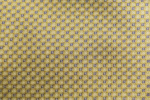 A yellow and black patterned fabric with squares photo