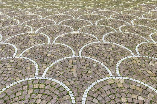 A brick paved area with a circular pattern photo
