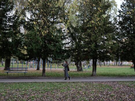 A man in a suit is walking down a path photo