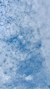 a blue sky with clouds and a power line photo
