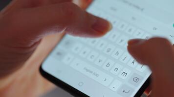 Woman chatting online on smartphone close up, typing text message, touching touchscreen keyboard, using messenger application. Female holding mobile phone. video