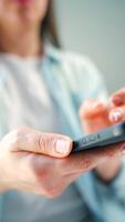 Woman scrolling through social media feeds on smartphone close up, using messenger application. Vertical video