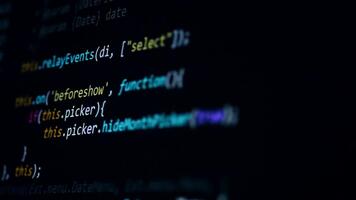 Macro closeup of JavaScript code scrolling across dark monitor. video