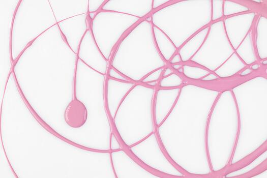 Soft circular lines of pink acrylic paint on a white surface. a large drop in the center of the drawing. simplicity of design.top view. modern style. photo