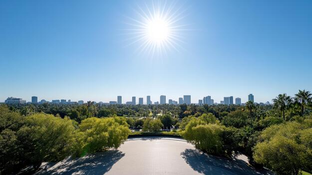 The sun shines over a park with trees and buildings photo