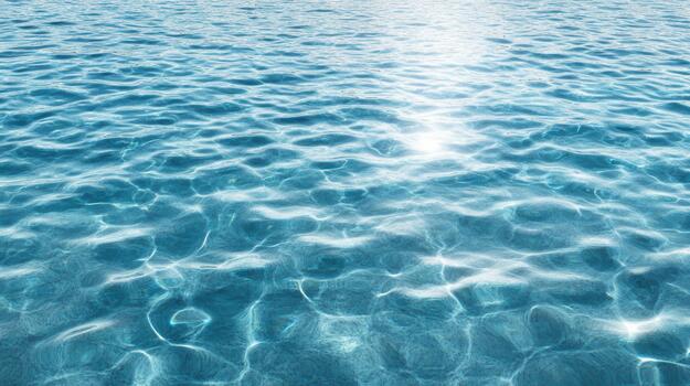 Sparkling turquoise water with sunlit reflections and gentle ripples photo