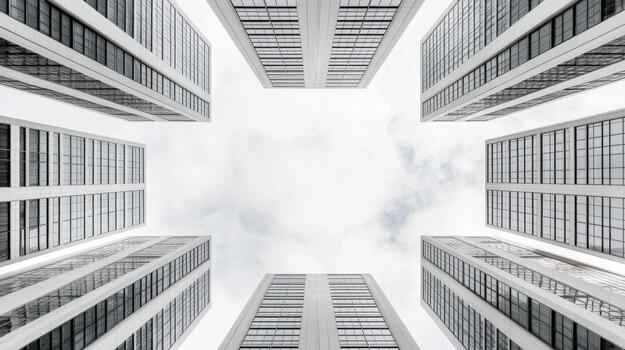 Modern highrise building facades forming symmetrical vertical perspective with cloudy sky photo