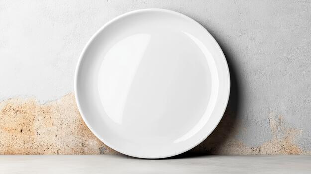 Blank white ceramic plate on textured concrete surface with subtle shadow and serenity photo