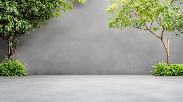 Minimalist concrete courtyard with two leafy trees framing calm neutral backdrop photo