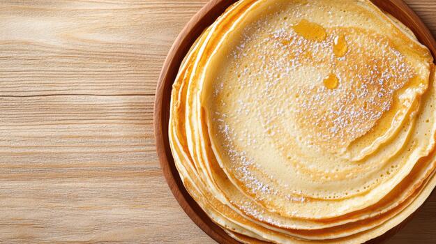 Stacked pancake crepe with syrup and powdered sugar on wooden plate, warm breakfast close up photo