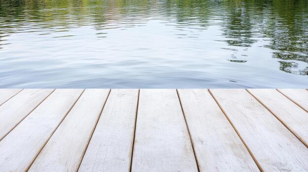 White wooden dock foreground with calm reflective lake and tree reflections photo