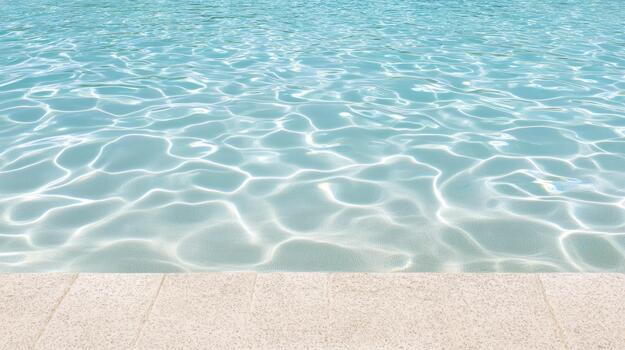 Clear shallow pool water with shimmering sunlight reflections and serene edge photo
