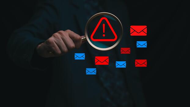 Email security warning concept with a magnifying glass highlighting a red alert symbol among multiple email icons, representing cyber risk detection, phishing analysis, spam protection, and digital photo