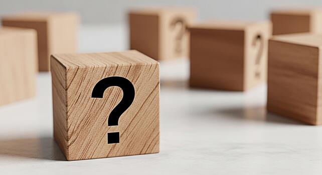 Wooden blocks displaying question marks on a neutral surface representing uncertainty and inquiry in a minimalist setting fostering curiosity and problemsolving ideal for educational and business conc photo