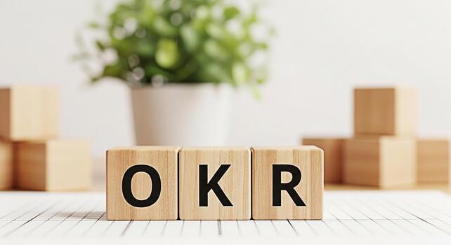 Wooden blocks spelling OKR on a table in a bright office environment representing Objectives and Key Results a strategic framework for defining and tracking objectives and outcomes promoting focus and photo