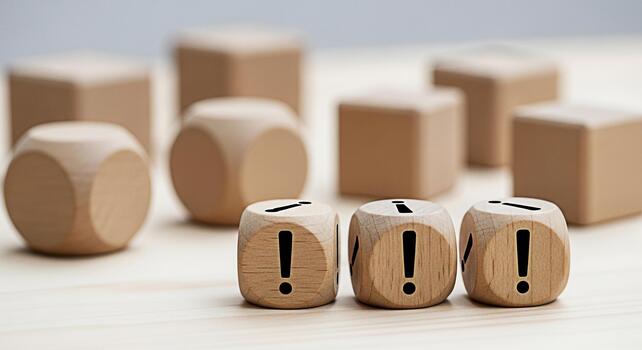 Wooden dice displaying exclamation points on a light wooden surface creating a sense of urgency and highlighting important information emphasizing attention to detail and critical thinking in a minima photo