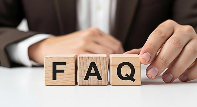 Professional man arranging wooden blocks spelling FAQ on a white table symbolizing answers to frequently asked questions providing clarity and support in a business environment photo
