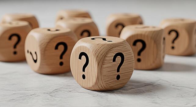 Wooden question mark dice scattered on a light textured surface symbolizing uncertainty choices and the search for answers in complex situations photo