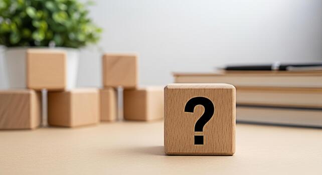 Wooden question mark block standing prominently on a clean desk with a blurred office background evoking curiosity problemsolving and the search for solutions in business and educa photo