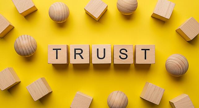 de madera bloques ortografía confiar claramente desplegado en un brillante amarillo superficie representando núcleo valores de integridad fiabilidad y fuerte cimientos en negocio y personal Conectar foto