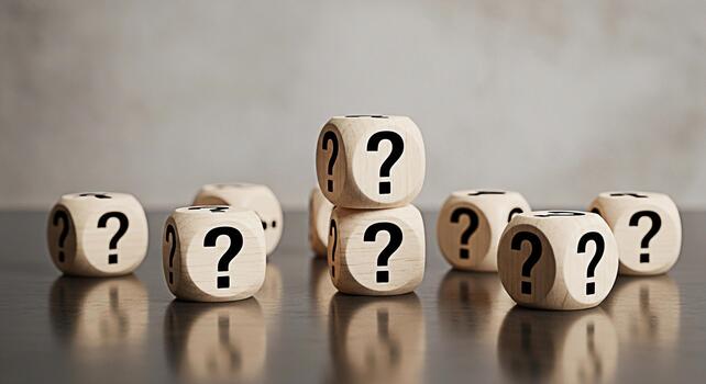 Multiple wooden dice with prominent question marks scattered and stacked on a reflective dark surface symbolizing uncertainty choices and the search for answers or solutions in com photo