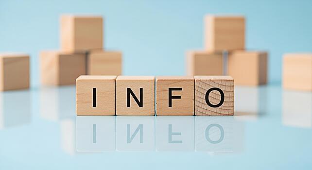 Wooden blocks spelling INFO on a reflective surface against a light blue background conveying a message of knowledge and awareness in a clean and minimalist setting ideal for educational or informativ photo