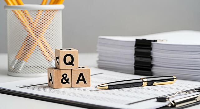 Wooden blocks displaying Q A on a desk with financial documents and a pen symbolizing questions and answers in a business setting fostering a clear and informative atmosphere photo