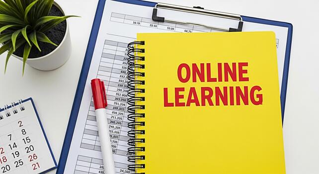 Bright yellow notebook displaying Online Learning on a white desk with a calendar plant marker and financial data symbolizing education remote study and the modern learning environment photo