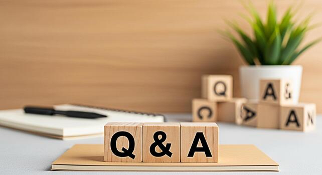 Wooden blocks displaying Q A on a desk with a notebook and pen in a bright office setting symbolizing knowledge learning and problemsolving with a focus on questions and answers photo